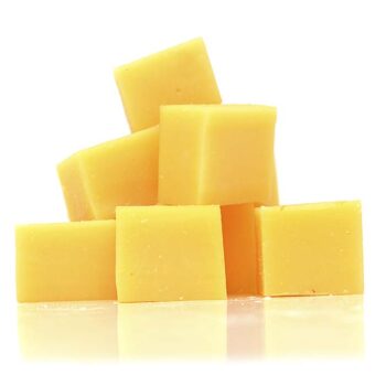 Cubes of cheddar cheese isolated on white